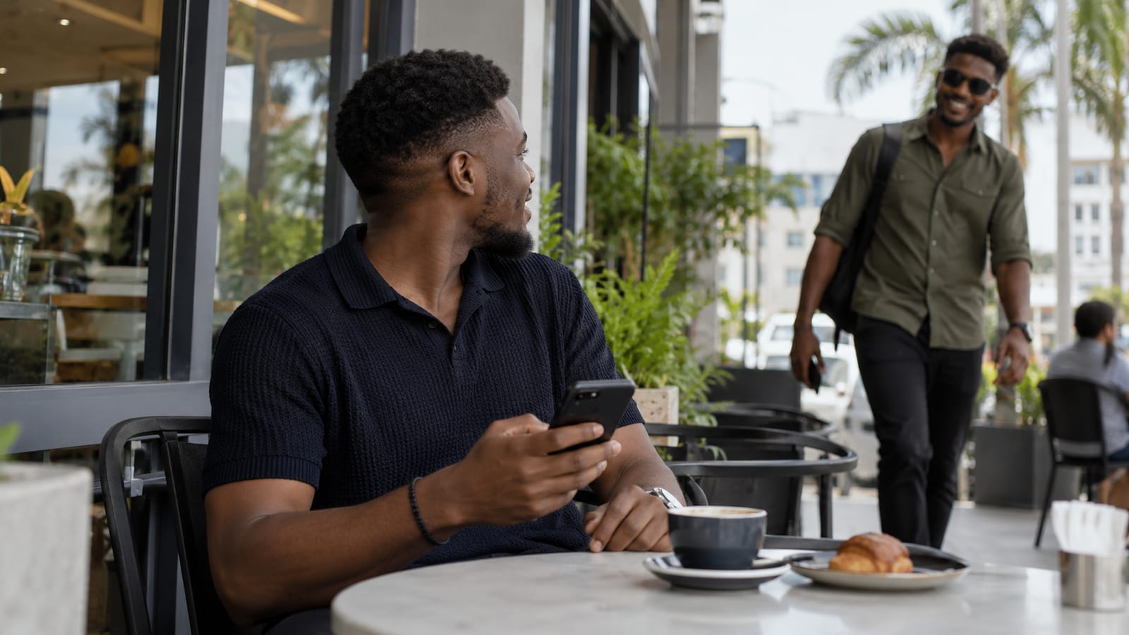 A person at a café noticing that a friend is nearby